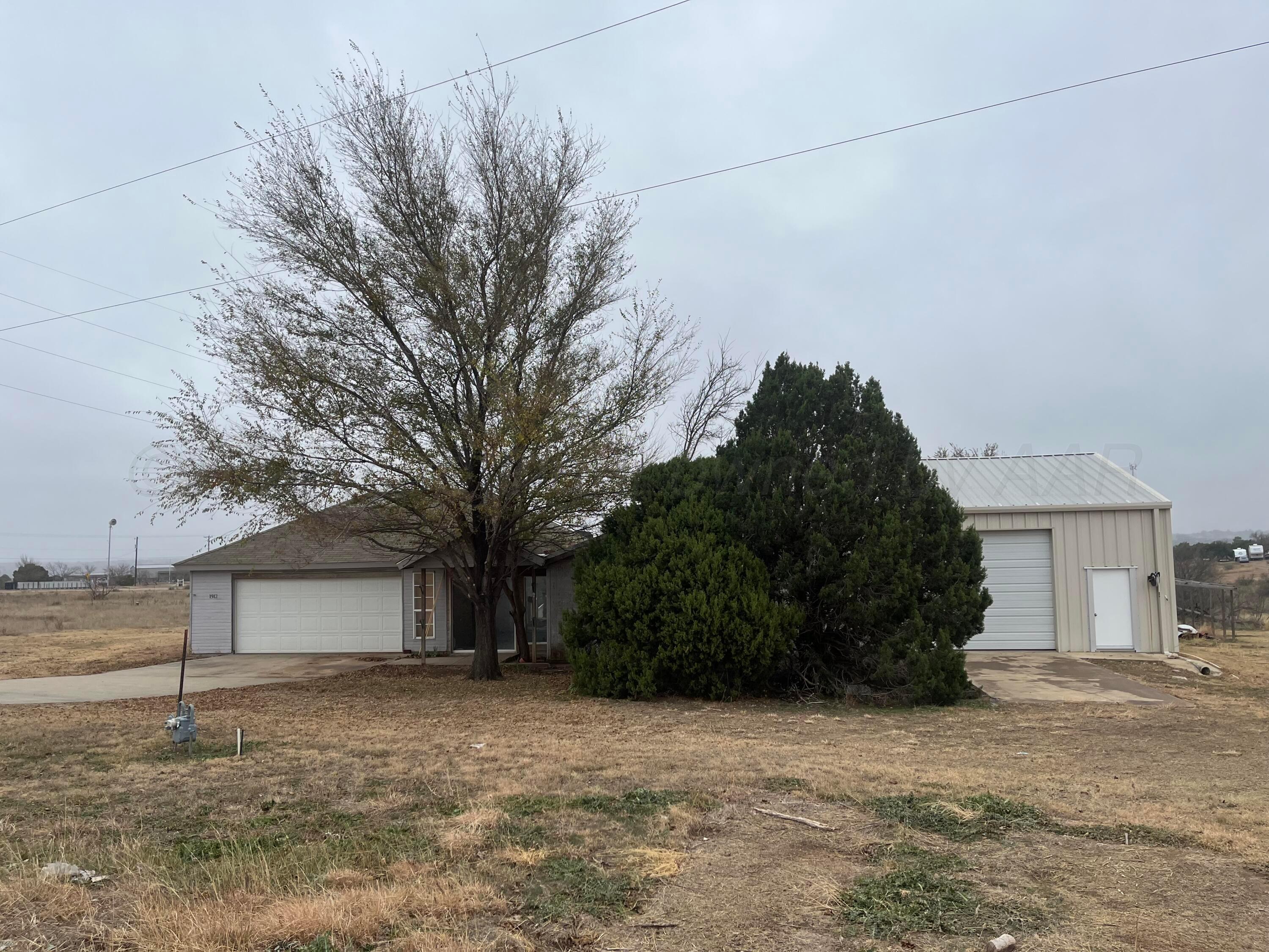 a view of a house with a yard and garage