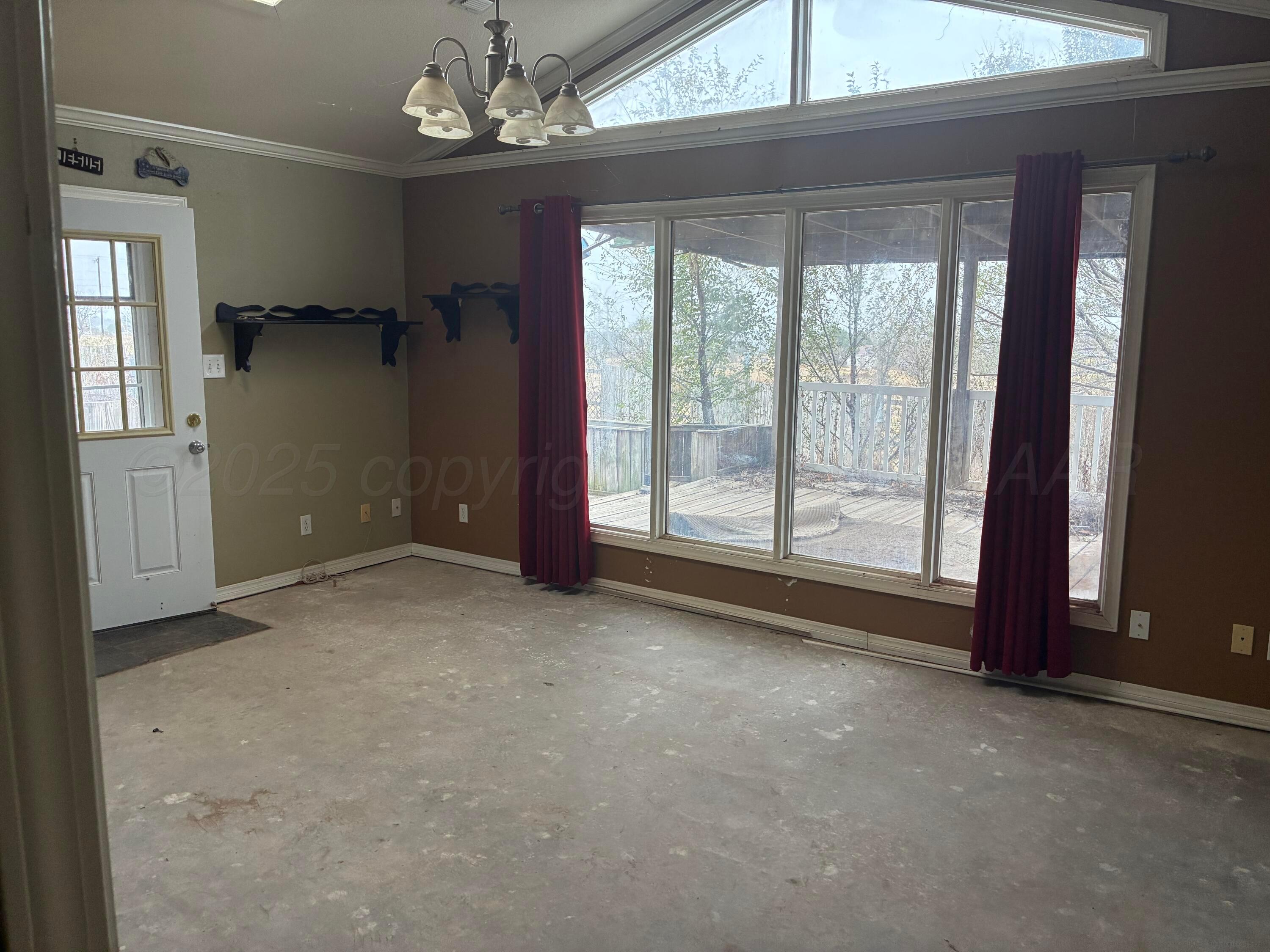 1912 Rimsite Drive Amarillo, TX 79118 - Photo 5 of 9 an empty room with windows and painted walls