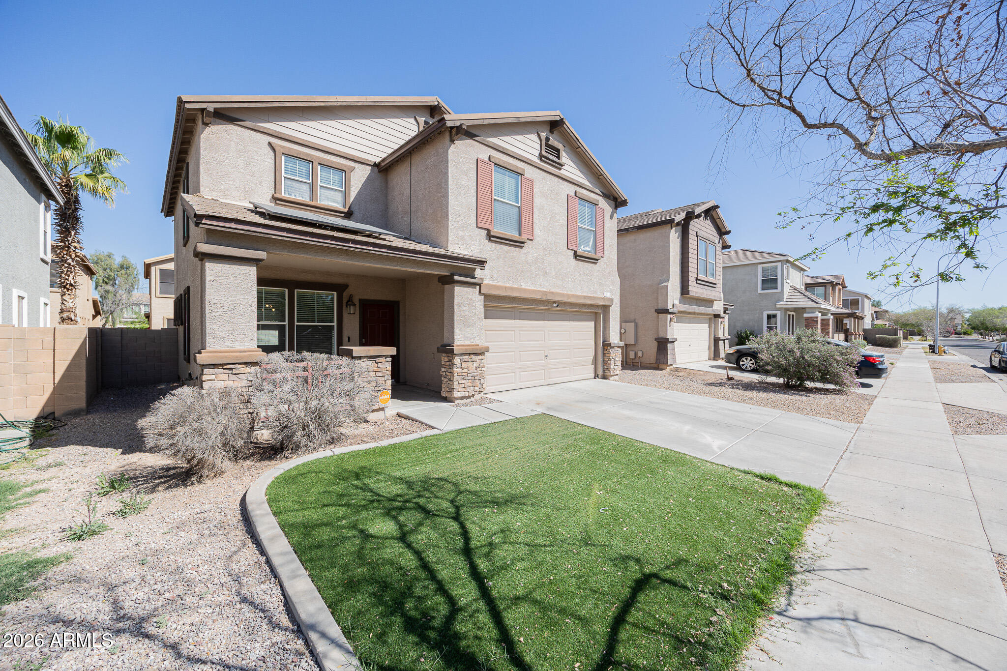 a front view of a house with a garden and pathway