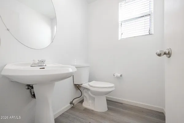 a bathroom with a sink toilet and a mirror