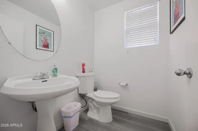 a bathroom with a sink toilet and a mirror