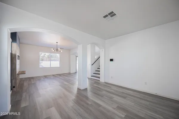 a view of empty room with wooden floor