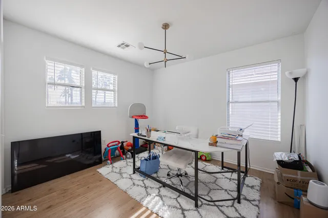 a view of a workspace with furniture and a window
