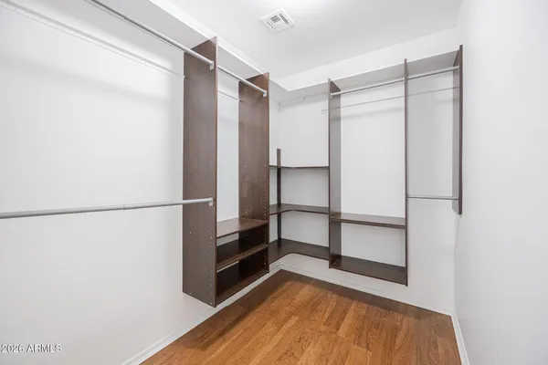 a view of walk in closet with empty racks