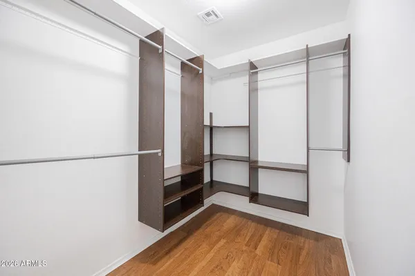 a view of walk in closet with empty racks