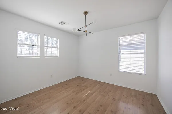 a view of a room with wooden floor and windows