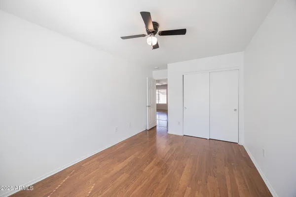 a view of empty room with wooden floor