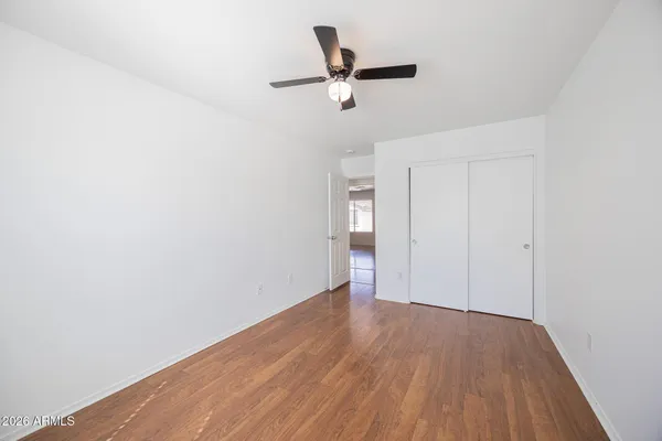 a view of empty room with wooden floor