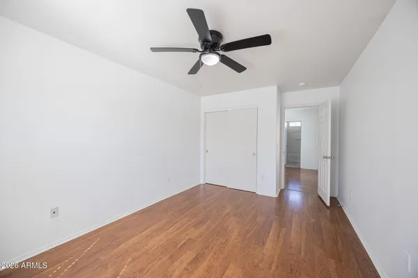 a view of empty room with wooden floor