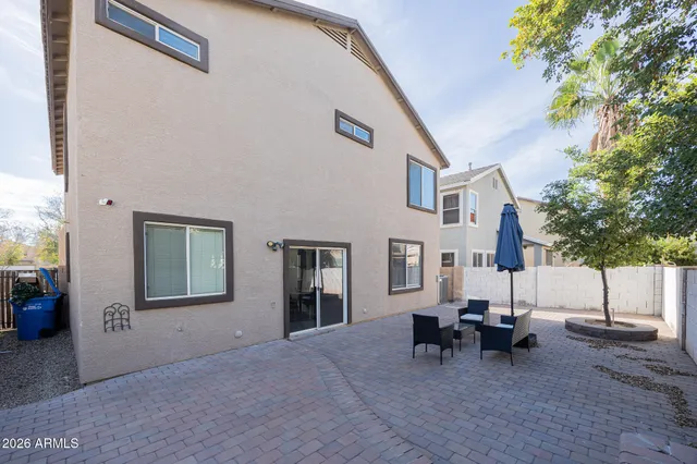 a view of a house with backyard and sitting area