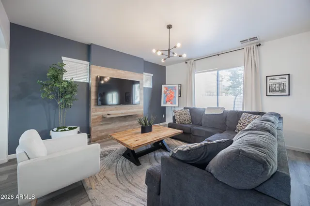 a living room with furniture and a flat screen tv