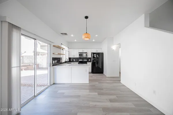 a kitchen with white cabinets and white appliances