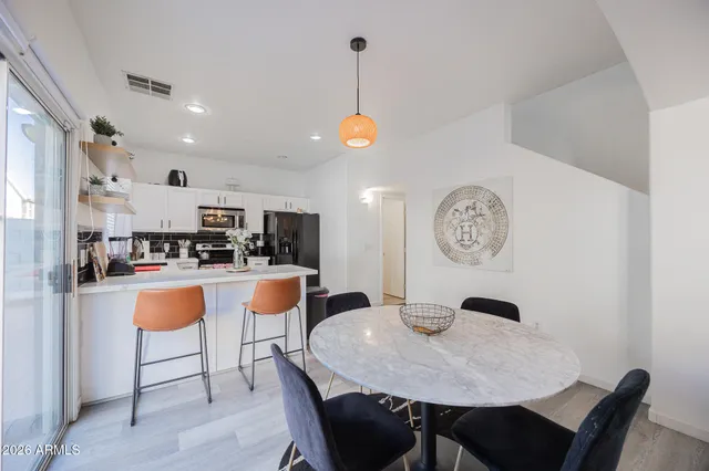 a living room with dining table and chairs