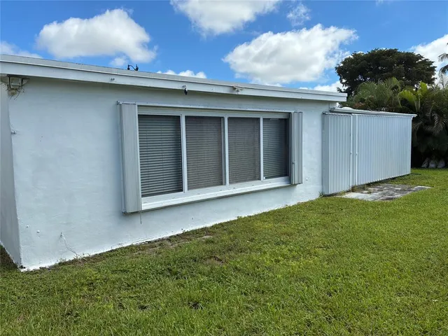 a view of an house with backyard space and balcony