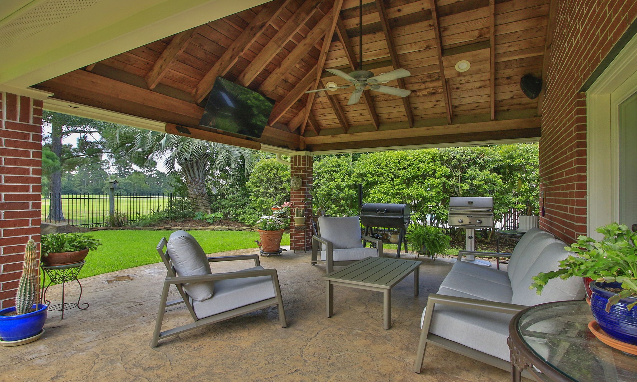 20110 Stormy Pine Lane Spring, TX 77379 - Photo 34 of 44 The oversized covered patio with vaulted ceiling and ceiling fan offers generous space for lounging, dining and entertaining.