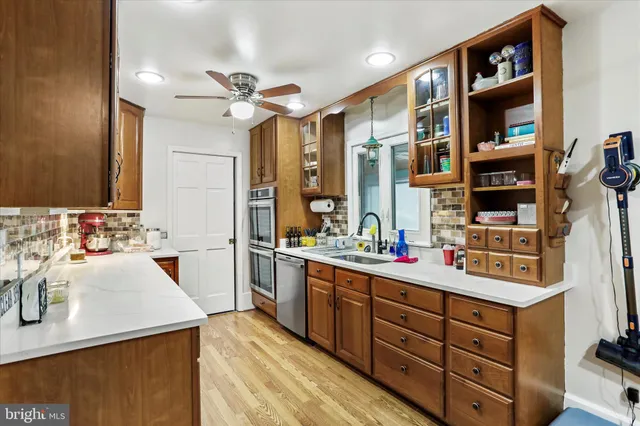 a kitchen with a sink stove and cabinets