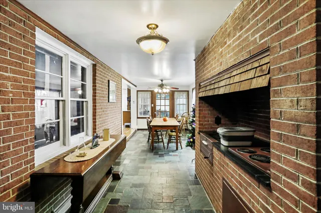 a living room with patio furniture and a flat screen tv
