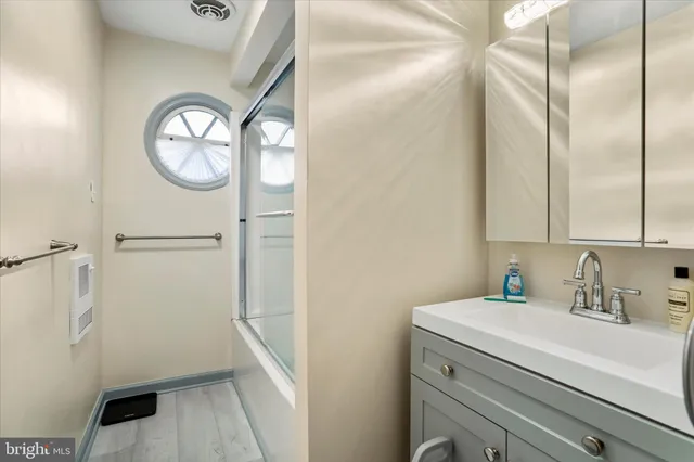 a bathroom with a sink a mirror and a shower