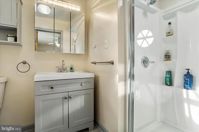 a bathroom with a sink a toilet and shower