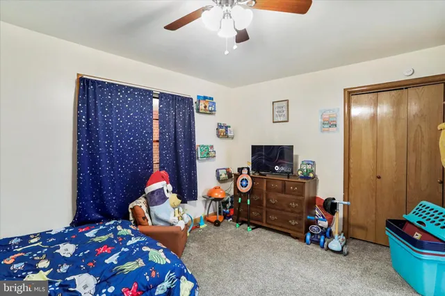 a bedroom with bed and tv