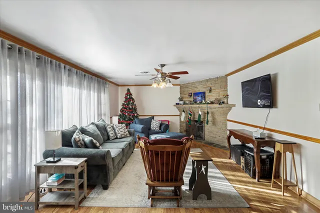 a living room with furniture a flat screen tv and couches