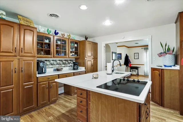a kitchen that has a lot of cabinets a sink and a stove in it