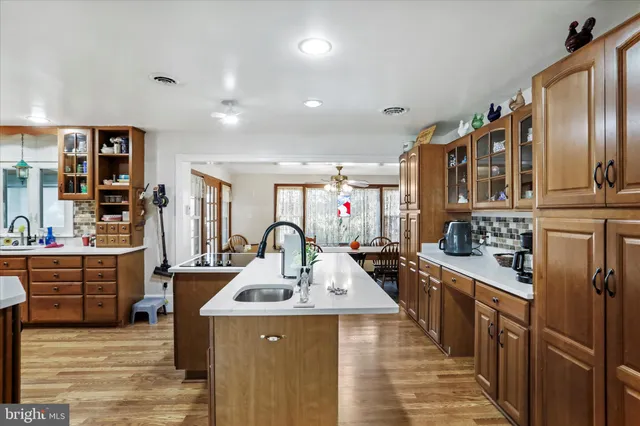 a kitchen with stainless steel appliances a sink stove and cabinets