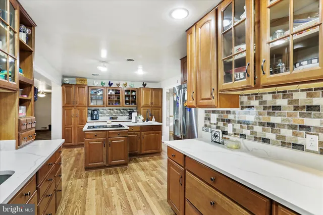 a kitchen with stainless steel appliances granite countertop a sink and cabinets