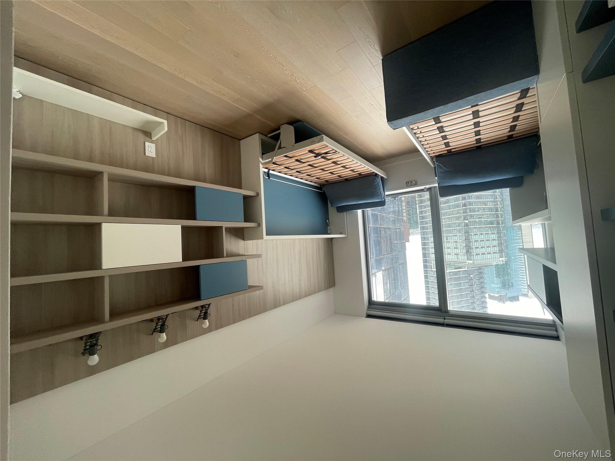 3 Court Square Queens, NY 11101 - Photo 4 of 7 a bedroom with furniture and window