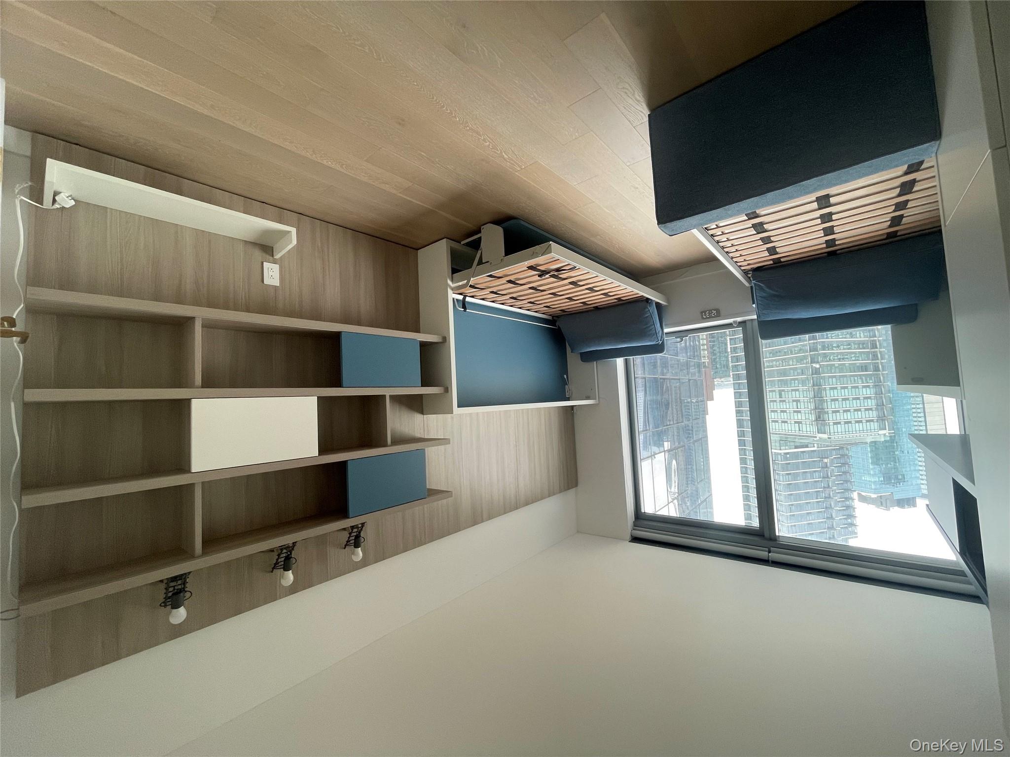 3 Court Square Queens, NY 11101 - Photo 6 of 7 a living room with furniture and a window