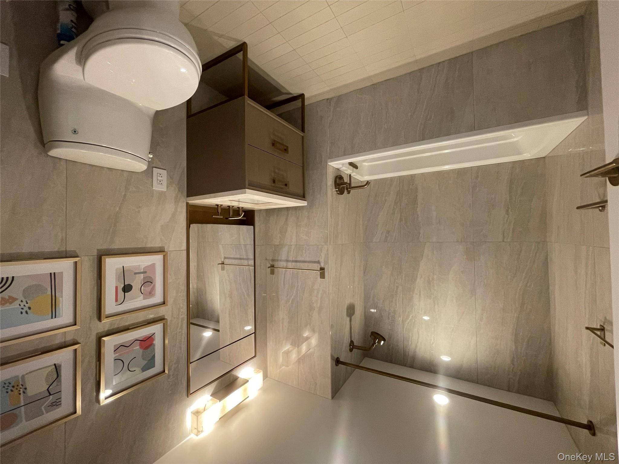 3 Court Square Queens, NY 11101 - Photo 7 of 7 a bathroom with a toilet a sink and bathtub