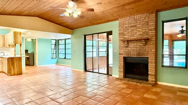 a view of a hallway with wooden floor and a chandelier