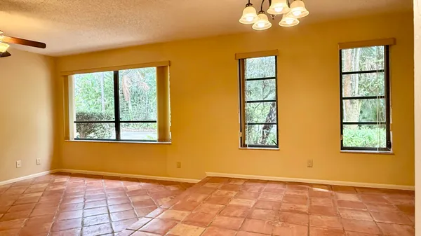 an empty room with a bathroom and a mirror