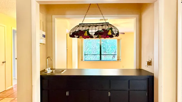 a bathroom with a granite countertop tub and a sink