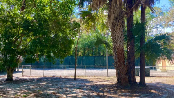 a view of swimming pool with outdoor seating and trees