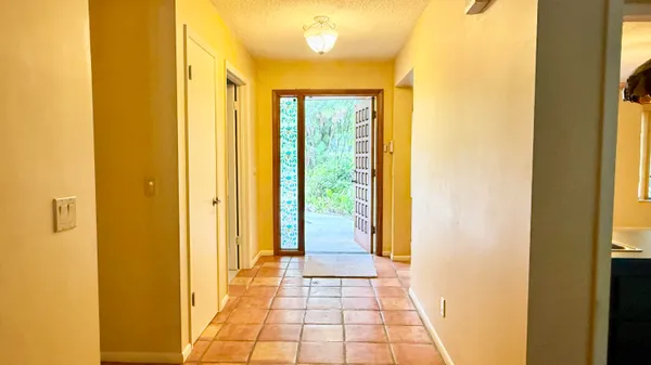 a view of an empty room with a fireplace and a window