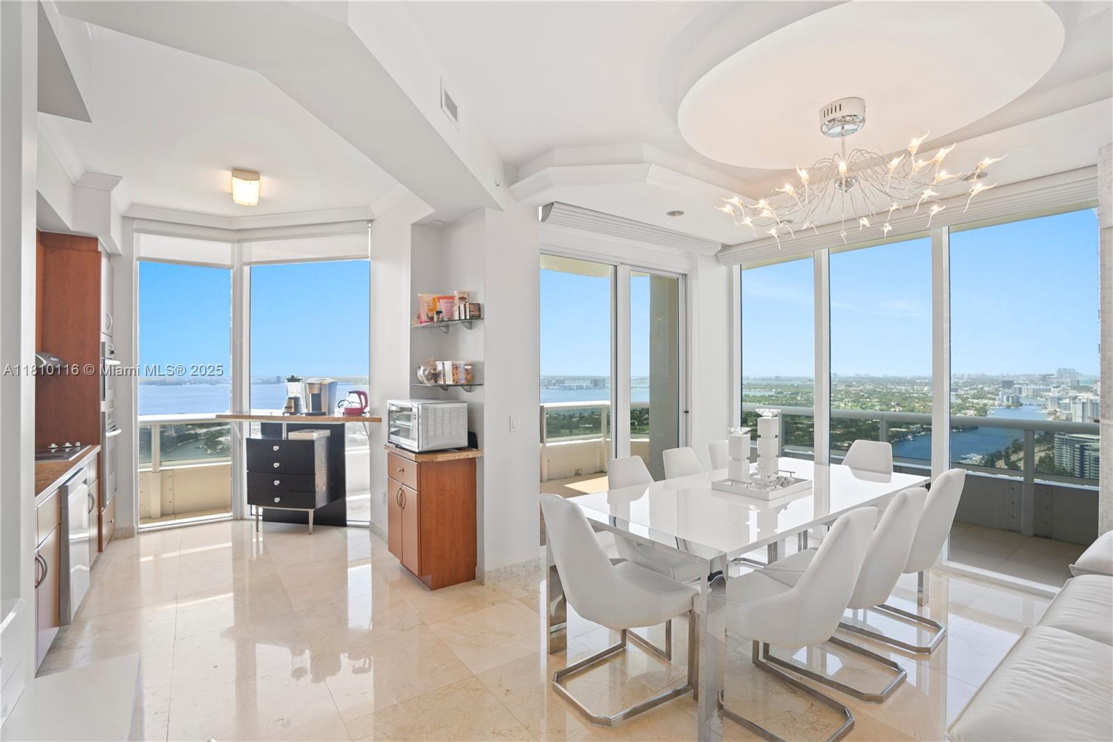 4775 Collins Avenue, Unit PH4107 Miami Beach, FL 33140 - Photo 13 of 62 a view of a dining room with furniture window and outside view