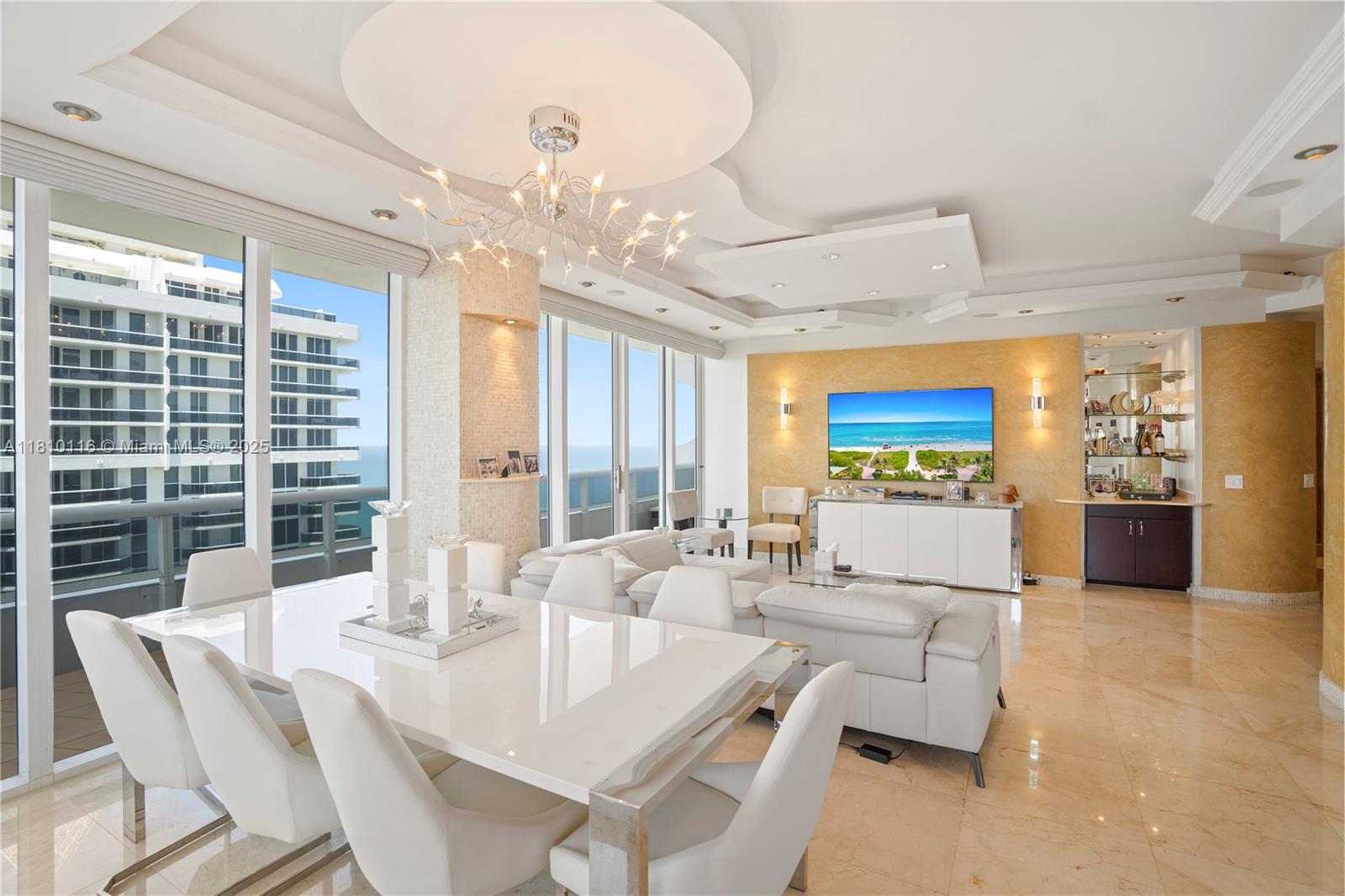 4775 Collins Avenue, Unit PH4107 Miami Beach, FL 33140 - Photo 18 of 62 a view of a dining room with furniture large windows and wooden floor