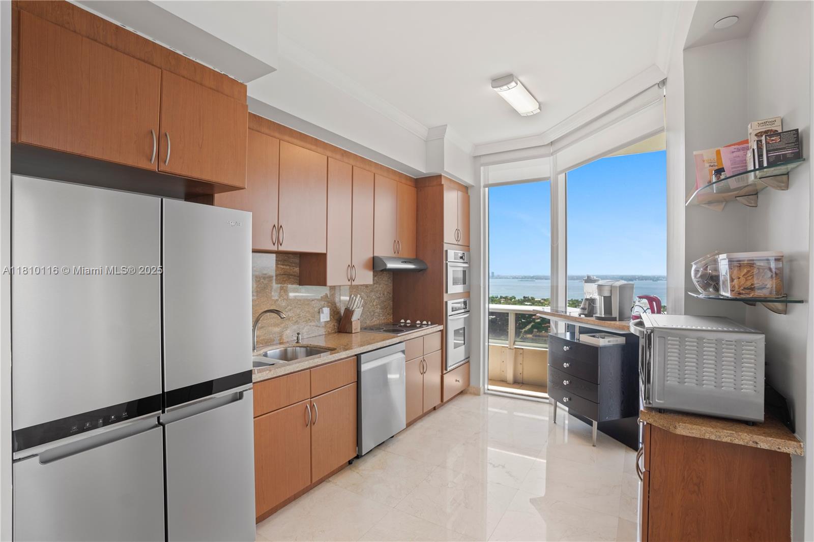 4775 Collins Avenue, Unit PH4107 Miami Beach, FL 33140 - Photo 20 of 62 a kitchen with a refrigerator a stove top oven a sink and dishwasher with wooden floor