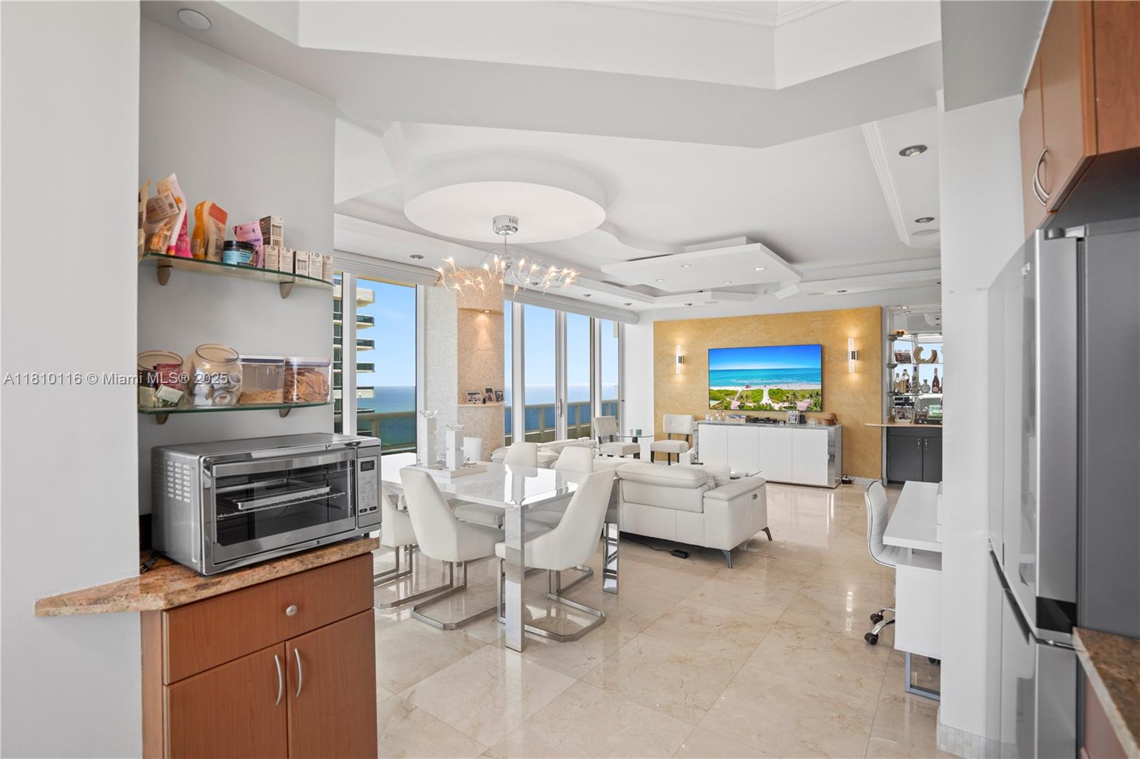 4775 Collins Avenue, Unit PH4107 Miami Beach, FL 33140 - Photo 24 of 62 a living room with furniture and a flat screen tv