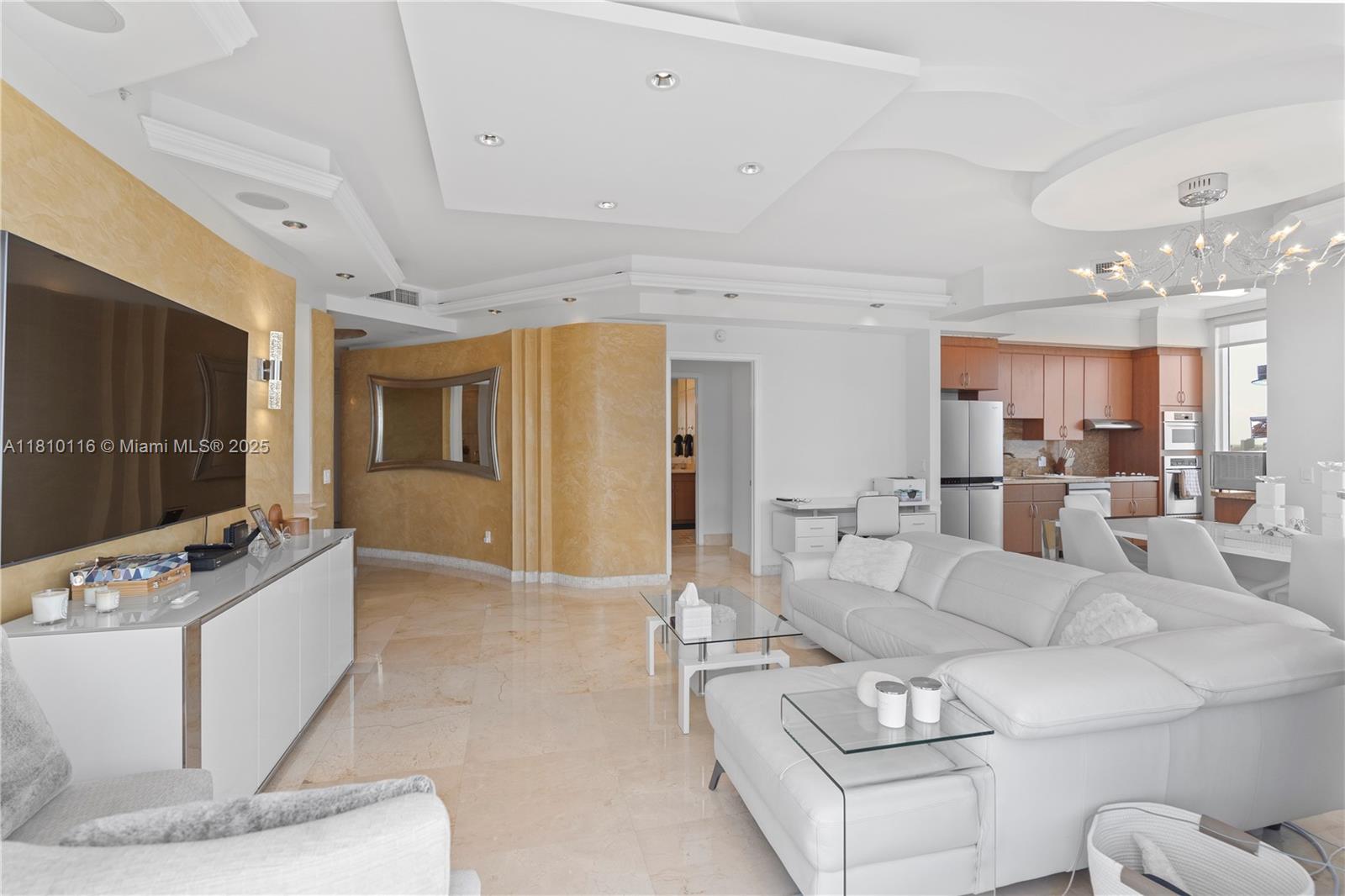 4775 Collins Avenue, Unit PH4107 Miami Beach, FL 33140 - Photo 25 of 62 a living room with furniture and a flat screen tv