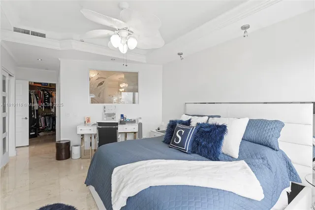 a bedroom with two beds and large mirror