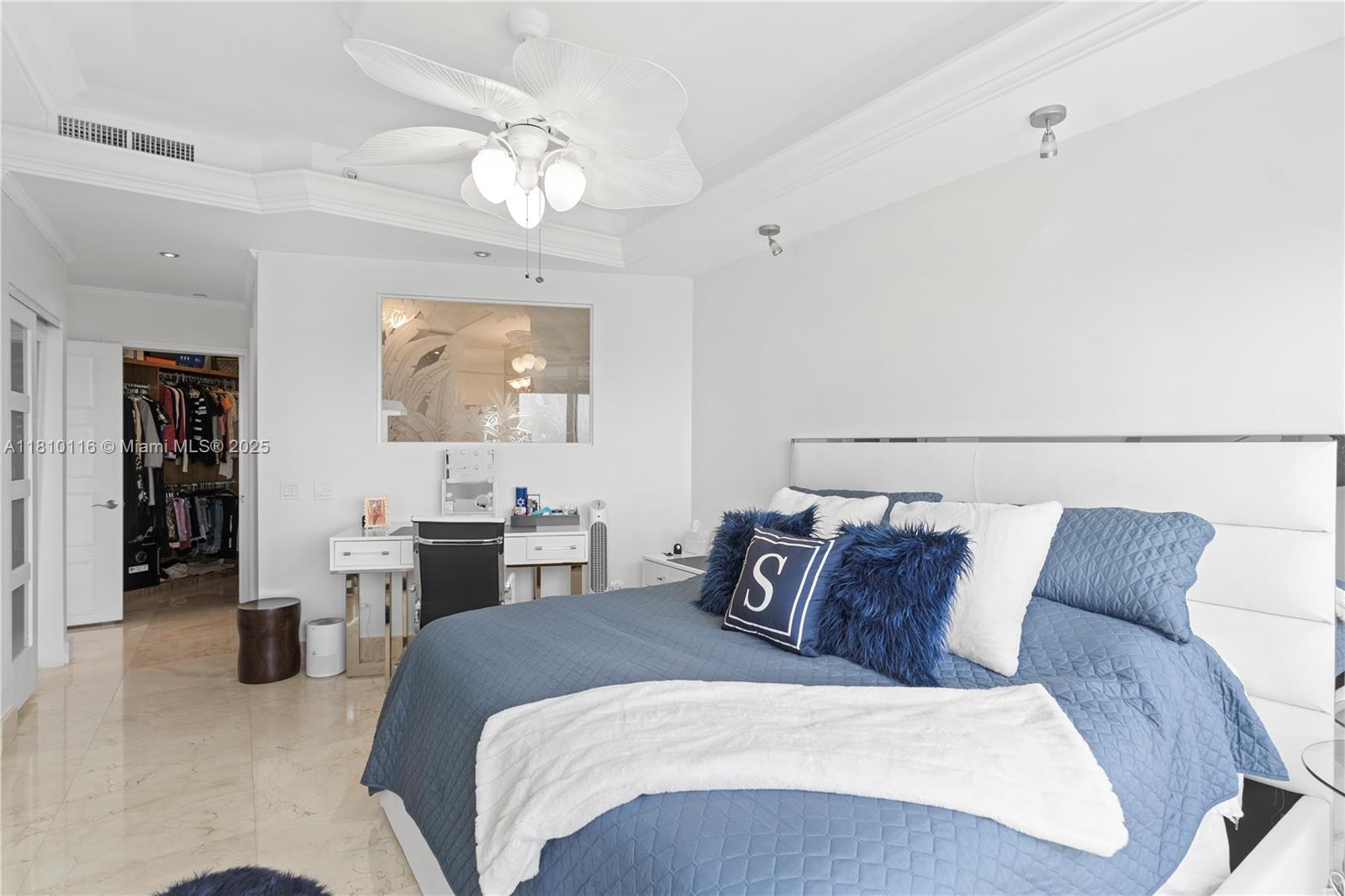 4775 Collins Avenue, Unit PH4107 Miami Beach, FL 33140 - Photo 30 of 62 a bedroom with a large bed and a chandelier