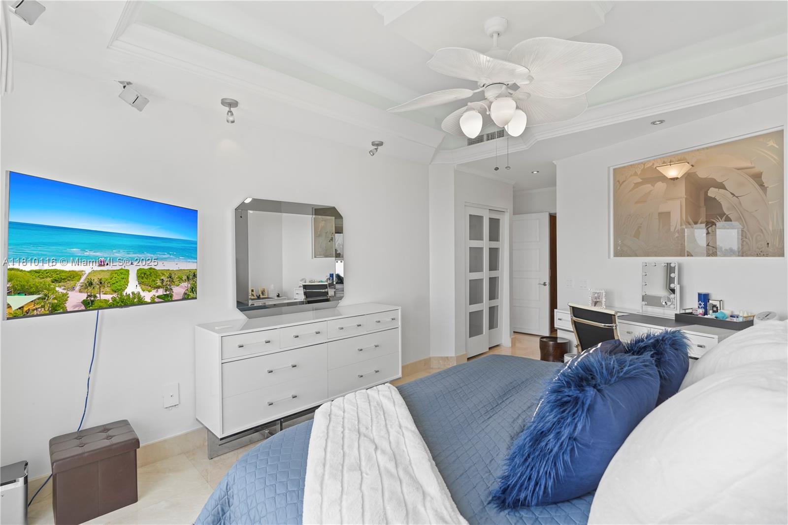 4775 Collins Avenue, Unit PH4107 Miami Beach, FL 33140 - Photo 31 of 62 a bedroom with a bed and a chandelier