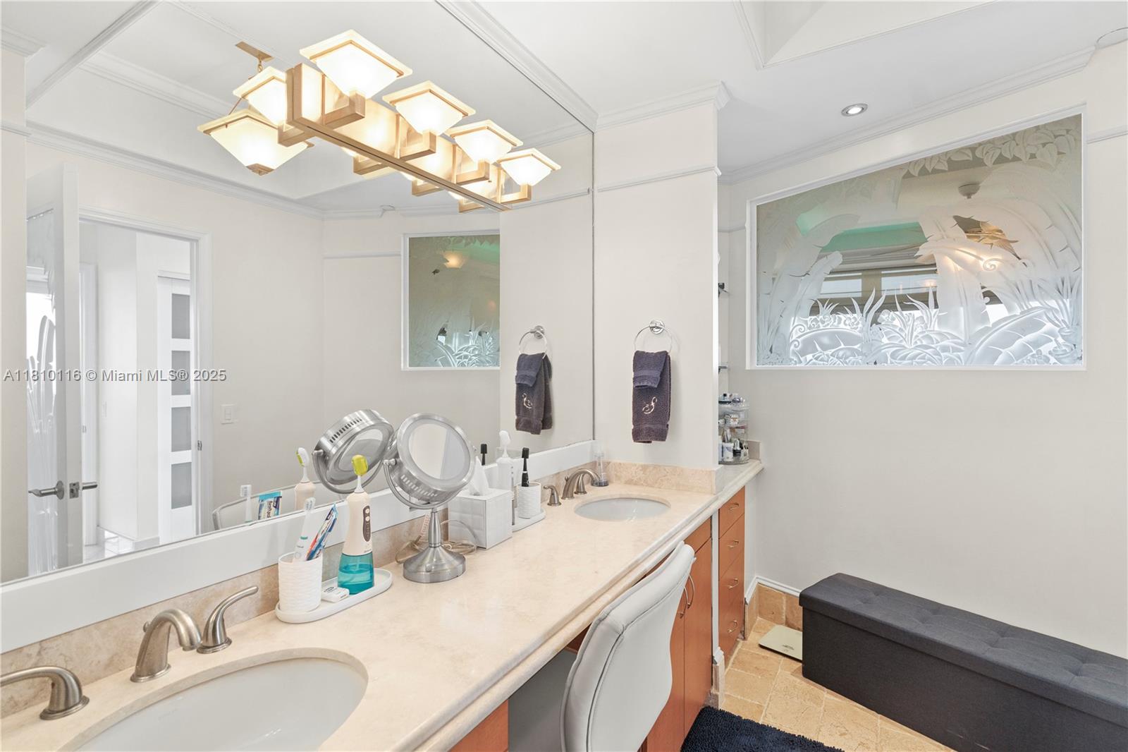 4775 Collins Avenue, Unit PH4107 Miami Beach, FL 33140 - Photo 33 of 62 a bathroom with a sink a vanity and a mirror
