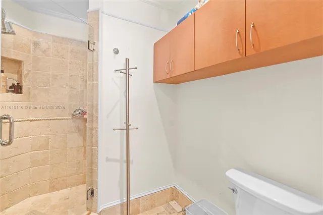 a bathroom with a shower and a glass door