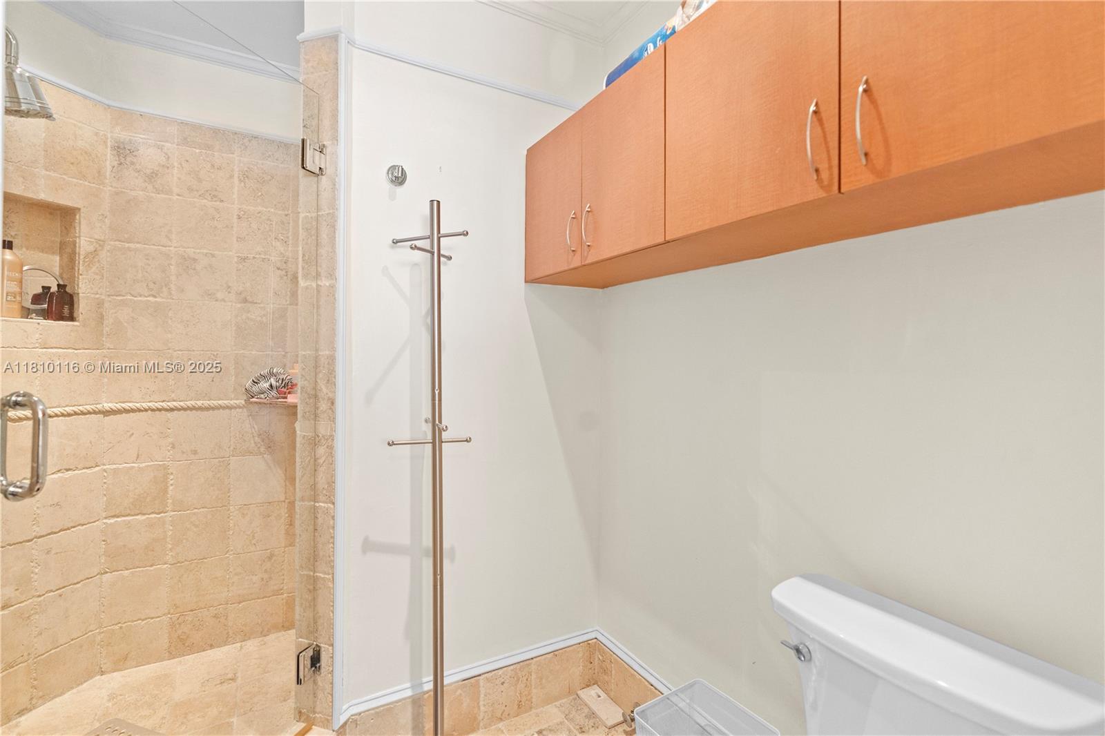 4775 Collins Avenue, Unit PH4107 Miami Beach, FL 33140 - Photo 34 of 62 a bathroom with a sink a toilet and shower