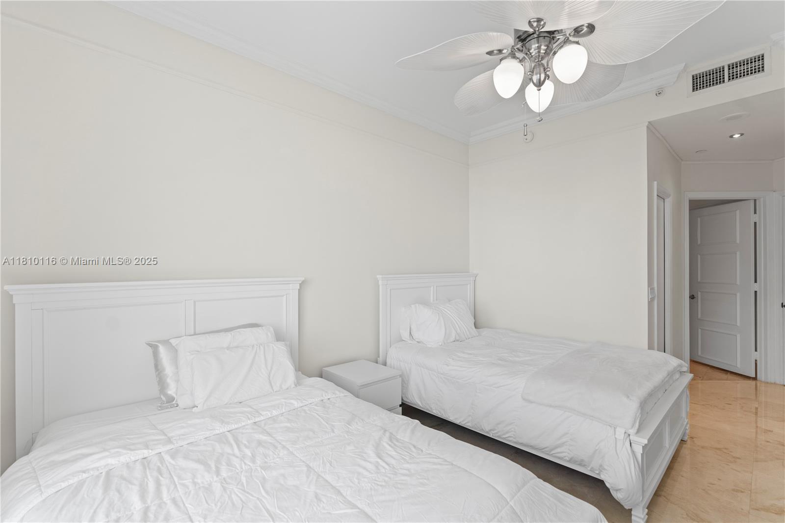 4775 Collins Avenue, Unit PH4107 Miami Beach, FL 33140 - Photo 35 of 62 a bedroom with a large bed and a chandelier