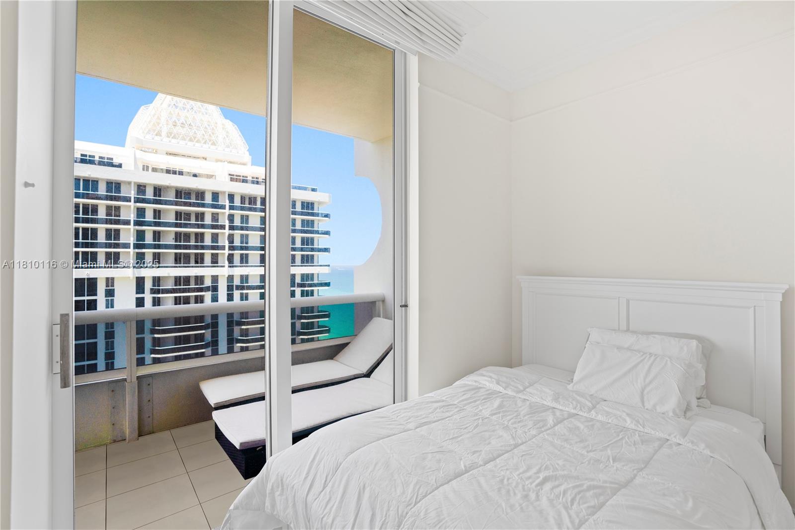 4775 Collins Avenue, Unit PH4107 Miami Beach, FL 33140 - Photo 36 of 62 a bedroom with a bed and a window