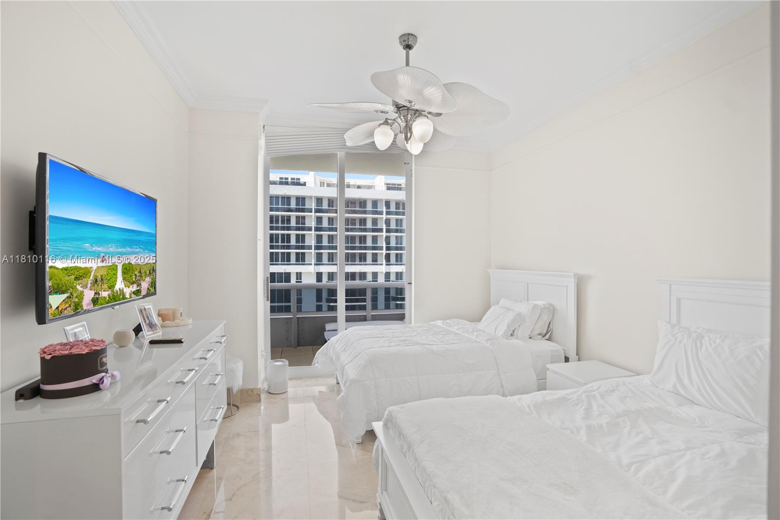 4775 Collins Avenue, Unit PH4107 Miami Beach, FL 33140 - Photo 39 of 62 a bedroom with a bed and a flat screen tv